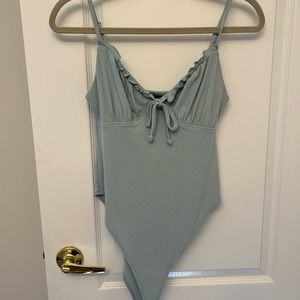 Blue body shit, tie in the front. Worn once.